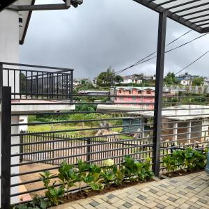 a view from the balcony of a building with plants at Pensive Villa in Nuwara Eliya