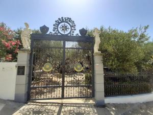 a gate with statues on top of it at Pansion Ana in Podaca