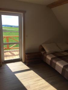 a bedroom with a bed and a large window at Zakątek Mikołajewo 14 in Mikolajewo +64 photos