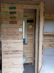 a room with two bunk beds in a log cabin at orchard meadow shepherd huts leek-buxton-ashbourne in Upper Elkstone