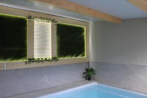 a bathroom with a window and a bath tub at Can Musiquem amb Piscina in Les Planes d'Hostoles