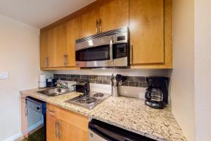 a kitchen with a sink and a microwave at Fraser Crossing 3404 in Winter Park