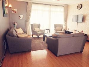 a living room with two couches and a table at Salmiya Place 2 in Nairobi