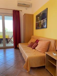 a bedroom with a bed with a teddy bear on it at Villa Vinki in Vinkuran