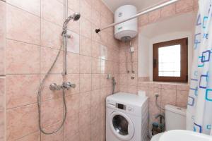 a bathroom with a shower and a washing machine at Luxury Seafront flat Perzagno 3 in Prčanj