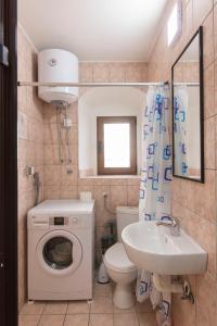 a bathroom with a washing machine and a sink at Luxury Seafront flat Perzagno 3 in Prčanj