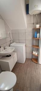 een witte badkamer met een wastafel en een toilet bij Apartment Bella in Pula