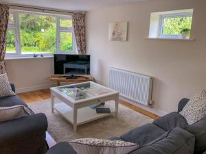 a living room with a couch and a coffee table at Highfield Cottage in West Hallam