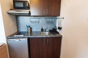 a small kitchen with a sink and a refrigerator at Little Explorer*Studio*DisneyLand*ValDeurope*Paris in Montévrain