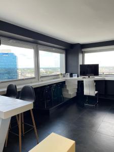 an office with a desk and chairs and windows at GreatView in Warsaw