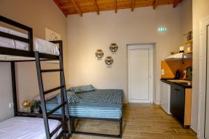 a bedroom with a bunk bed and a kitchen at Lila's Studios in Asprovalta