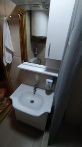 a bathroom with a white sink and a mirror at Brvnara Fairy Tale in Cetinje +54 photos