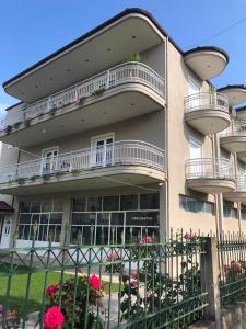 a building with balconies on the side of it at Rent Rooms Kapri in Pogradec