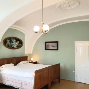 a bedroom with a large bed with an arched ceiling at Historic Farmhouse Kojetice in Kojetice