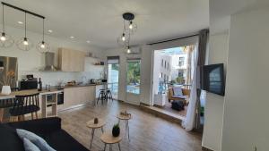 a living room and kitchen with a couch and a table at Elizabeth Suites in Kato Daratso