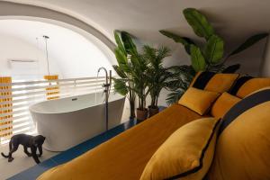 a bedroom with a large bed and a bath tub at relais metis in Naples