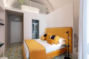 a bedroom with a bed with yellow pillows at relais metis in Naples