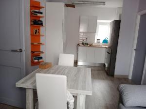 a kitchen with a table and two white chairs at Can Pitu Ferrer in Peralada