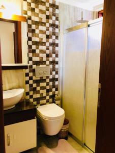a bathroom with a toilet and a sink at PEACEFUL HOUSE in Fethiye