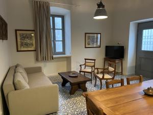 a living room with a couch and a table at Mercato Vecchio Guesthouse in Hydra