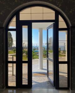 an entrance to a building with a large glass door at Hotel Black Sea in Sukhum