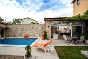 a backyard with a swimming pool and a house at Mejić Apartments in Kotor