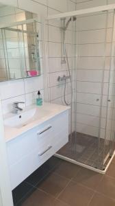 a bathroom with a sink and a shower at Modern basement apartments Stavanger, Sola airport, Kjerag, Preikestolen in Stavanger