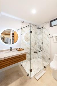 a bathroom with a shower and a sink at Boho Lofts & Studios in Playa del Carmen