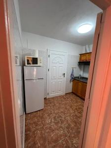 a kitchen with a white refrigerator and a microwave at Casa Blanca in Alojera +15 photos