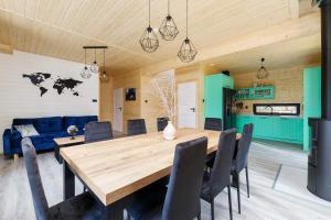 a dining room with a wooden table and chairs at Planeta 66 in Olsztynek