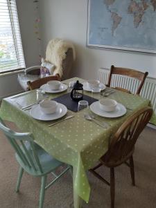 a table with a polka dot table cloth on it at Toppers Bright Seaview Family or Couple Home Devon Westward Ho! in Bideford