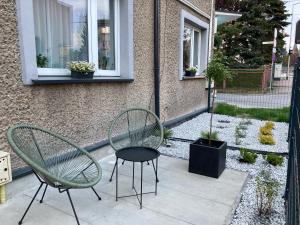 two chairs and a table on a patio at Apartament loft Krzeszowice centrum in Krzeszowice