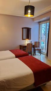 Ένα ή περισσότερα κρεβάτια σε δωμάτιο στο Hôtel Amouday