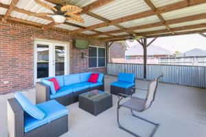 a patio with a couch and chairs and a table at Perfect Stay in Ranch-like House w Huge Backyard! in Forney