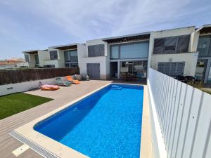 a swimming pool in the backyard of a house at Meco Beach Villa in Sesimbra