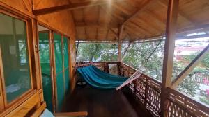 a hammock on a balcony of a house at Wasimita in Crucita