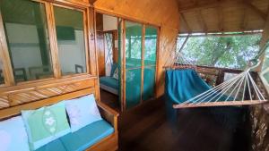 a room with two hammocks in a house at Wasimita in Crucita