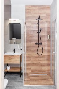 a bathroom with a shower and a sink at Kamienica Morska Gdynia in Gdynia