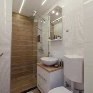 a bathroom with a sink and a toilet and a shower at Apartment Magnolia Old Town in Sarajevo