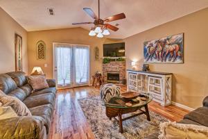 a living room with a couch and a table at High N Dry-Quiet River Access Neighborhood, 1 Mile to Parkway, 5 Miles to Dollywood! in Pigeon Forge