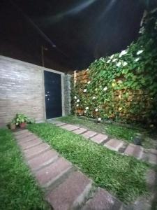 a garden at night with a brick wall and grass at FG in Tolosa