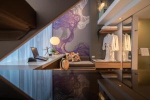 a boutique with a dressing room with a laptop on a table at Studio M Hotel in Singapore