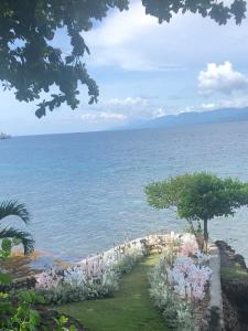 a wedding ceremony on the shore of the ocean at Wuthering Heights Bed & Breakfast by the Sea in Dumaguete