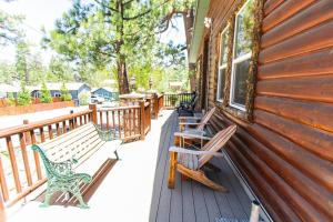 a porch with benches on the side of a house at Whispering Pines - Big Bear Lake in Big Bear Lake