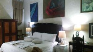 a bedroom with a bed with white sheets and pillows at Casa Falleri Boutique Hotel in Lima