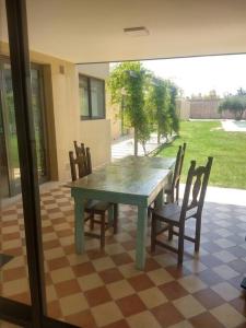 a green table and chairs on a checkered floor at Madame Chacras in Chacras de Coria +19 photos