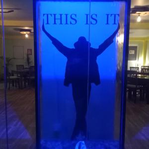 a silhouette of a woman holding a sign that says this is it at This Is It Airport Hotel and Restaurant in Negombo