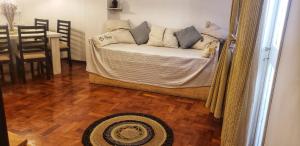 uma sala de estar com um sofá e um piso de madeira em Departamento céntrico Mendoza em Mendoza
