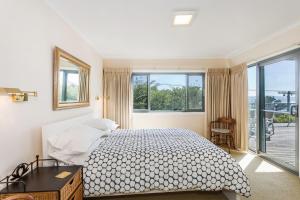 a bedroom with a bed and a large window at Anglesea Outlook in Anglesea