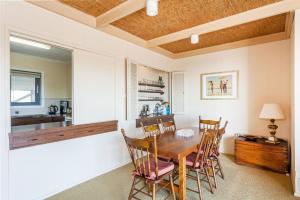 a dining room with a wooden table and chairs at Anglesea Outlook in Anglesea